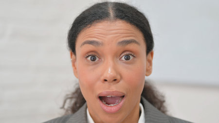 Close up of Surprised African Business Woman Enjoying Winの写真素材