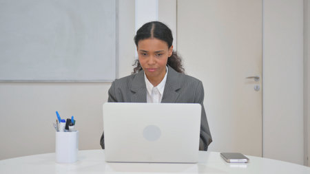 African Business Woman Shocked by Loss on Laptop