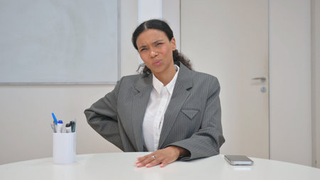 African Business Woman with Back Pain at Workの写真素材