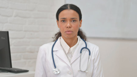 Portrait of Serious African Female Doctor Looking at Cameraの写真素材
