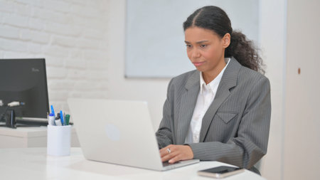African Business Woman Shocked by Loss on Laptopの写真素材