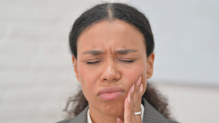 Close up of African Business Woman with Toothacheの写真素材