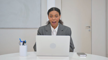 African Business Woman Celebrating Success on Laptop