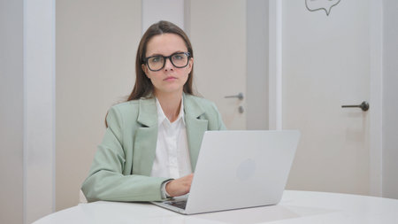 Young Woman Looking at Camera in Officeの写真素材