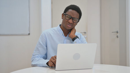African American Businessman with Neck Pain at Workの写真素材