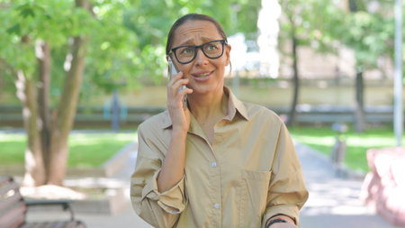 Multi Ethnic Woman Reacting with Concern on a Phone Callの写真素材