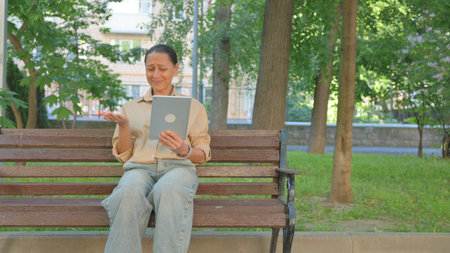 Multi Ethnic Woman Expressing Disbelief While Using a Tabletの写真素材