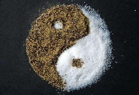 Yin-Yang made out of salt and pepperの写真素材