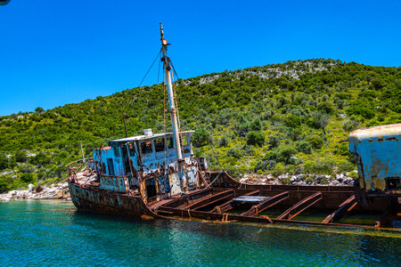 Seaside view over rusty shipwreck of an old cargo ship at Peristera island near Alonissos, Sporades, Greeceの写真素材