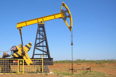 oil pump jacks working at dawn. A pumpjack on the plainsの写真素材