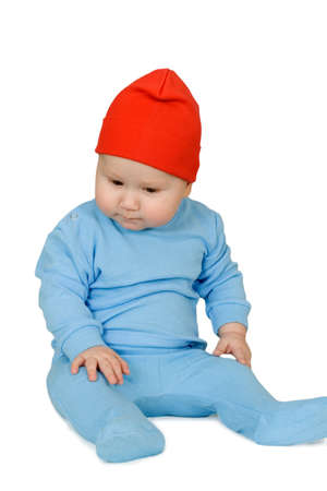 Adorable child is sitting on floor, wearing redの写真素材