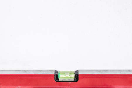 Red building level, side view on white background, isolated with space for text.の写真素材