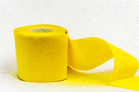 Yellow toilet paper full roll isolated on white background.の写真素材