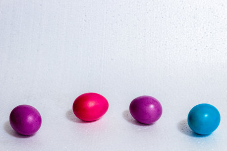 A group of four colored Easter eggs, the symbol of Easter. On white background.の写真素材