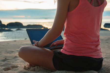 laptop girl on the beachの写真素材