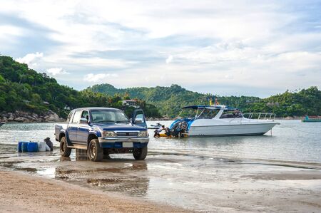 car and boat on the beachの写真素材