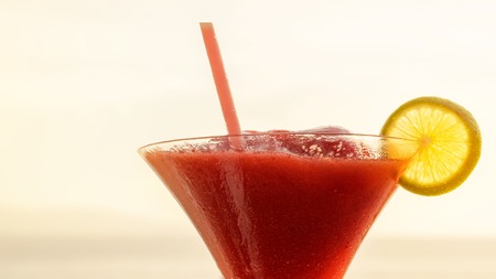 glass of cocktail on the sea. Refreshing drink on sunset backgroundの写真素材