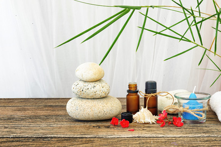 Spa still life with candle,zen stone and essential oil on wooden tableの写真素材