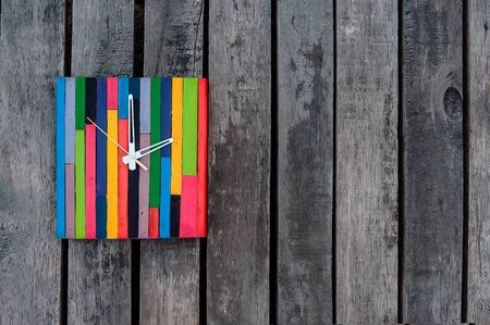 clock on the wooden wall backgroundの写真素材
