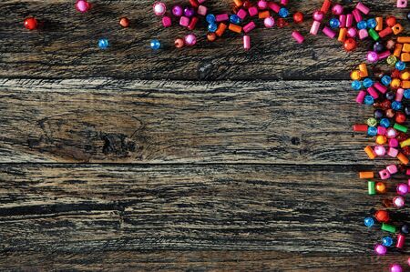 Colorful beads on wooden background above viewの写真素材