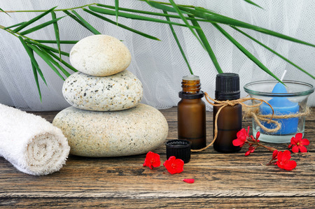 Spa still life with candle,zen stone and essential oil on wooden tableの写真素材
