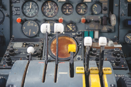 Detail of a old airplane cockpit .Abandoned Jet Airplane Cockpit Equipment with various indicators, buttons, and instruments. close upの写真素材