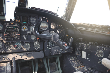Detail of a old airplane cockpit .Abandoned Jet Airplane Cockpit Equipment with various indicators, buttons, and instruments. close upの写真素材