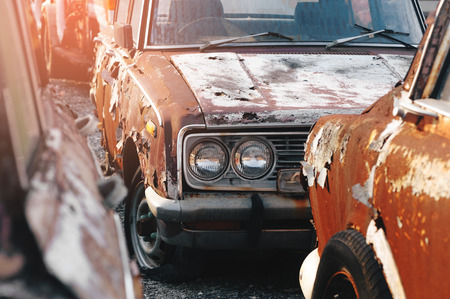 rows of abandoned cars outside facing each otherの写真素材