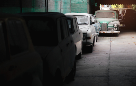 rows of abandoned cars outside facing each otherの写真素材