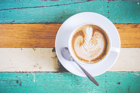 Top view Female hands holding cup of coffee. space for textの写真素材