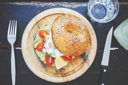 bagel with avocado, tomatoes and poached egg close up. view from aboveの写真素材