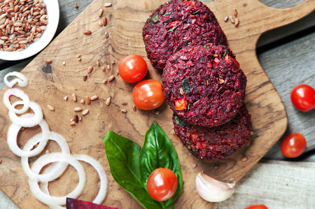Vegetable beetroot patties before cooking with various vegetables, mushrooms, avocado guacamole and herbs to a veggie burger. Concept of healthy organic food. Top viewの写真素材
