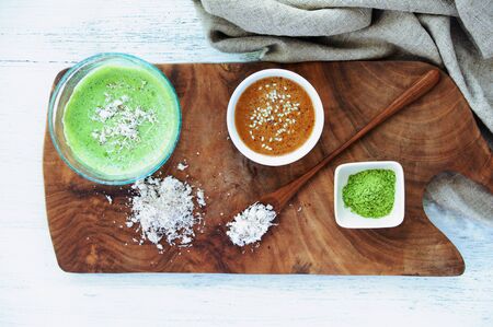 Healthy green smoothie of wheatgrass, tahini and coconutの写真素材