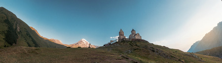 View of Kazbeg mountain and a cross, by the trinity church, Georgia, panoramic viewの写真素材