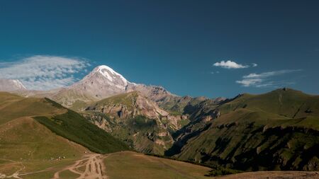 Mount Kazbek view from Stepantsminda town in Georgia in good weather for climbing. It is a dormant stratovolcano and one of the major mountains of the Caucasus.の写真素材