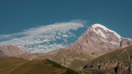 Mount Kazbek view from Stepantsminda town in Georgia in good weather for climbing. It is a dormant stratovolcano and one of the major mountains of the Caucasus.の写真素材