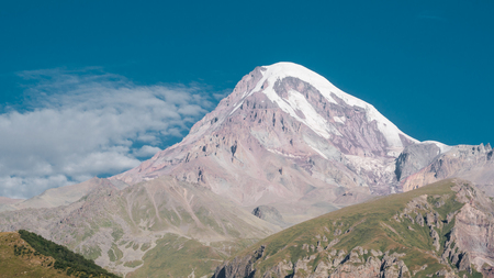 Mount Kazbek view from Stepantsminda town in Georgia in good weather for climbing. It is a dormant stratovolcano and one of the major mountains of the Caucasus.の写真素材