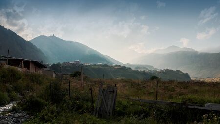 street of Stepantsminda with Gergeti Trinity Church on background, Georgiaの写真素材