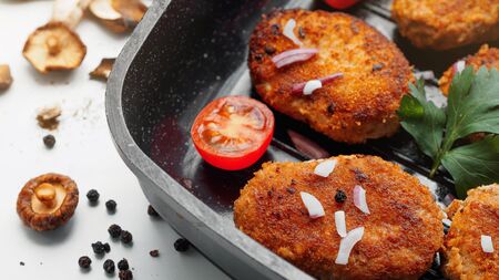 Homemade cutlets with mushrooms, fresh vegetables and herbs.の写真素材