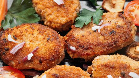 Homemade cutlets with mushrooms, fresh vegetables and herbs. close upの写真素材