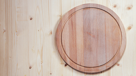 Background for product montage. empty round wooden board for cutting on a wooden background with copy spaceの写真素材