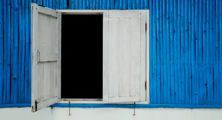 blue colored wood wall with old white wooden window, texture backgroundの写真素材