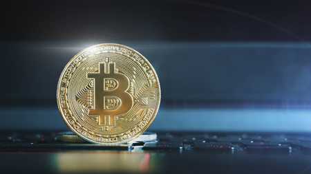 golden bitcoin on keyboard extreme closeupの写真素材