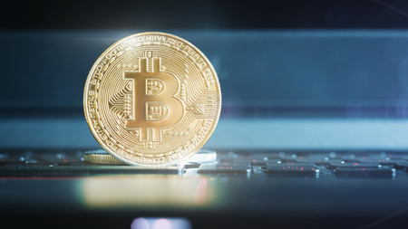 golden bitcoin on keyboard extreme closeupの写真素材