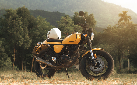 motorcycle parked on the road with sunset, select focusing background.の写真素材