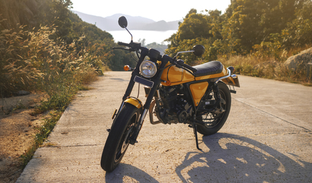 motorcycle parked on the road amazing sea view background.