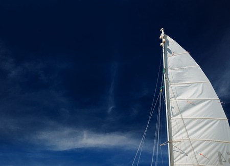Sail boat, catamaran, on tropical beach with blue waterの写真素材