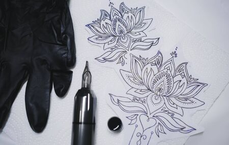 tattoo gun, stamp and some ink for tattoo.の写真素材