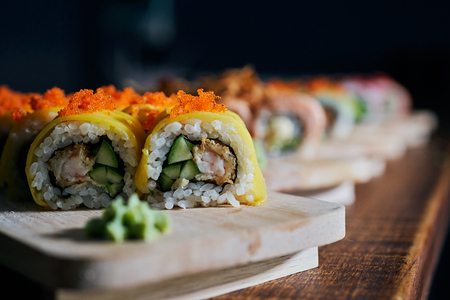 Various kinds of sushi served on wooden tableの写真素材