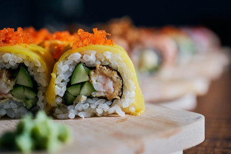 Various kinds of sushi served on wooden tableの写真素材
